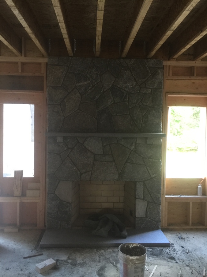 Fireplace - uses the same stone as outside; and the granite used in the patio for the mantle!  